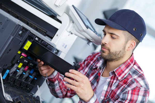 man-repairing-a-printer-at-work